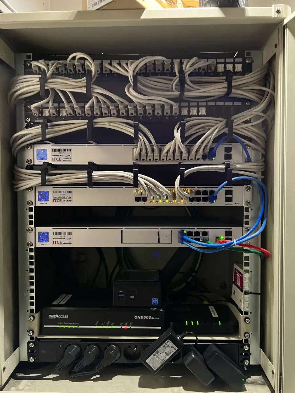 Netwerkkast met patchpanelen, switches en netjes gebundelde kabels